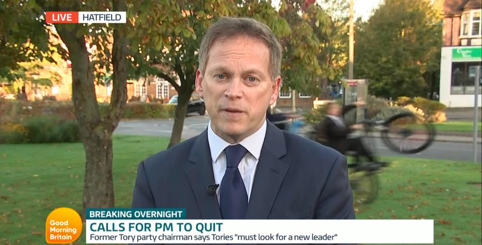  Ridiculed Grant Shapps is photobombed by lad on bike