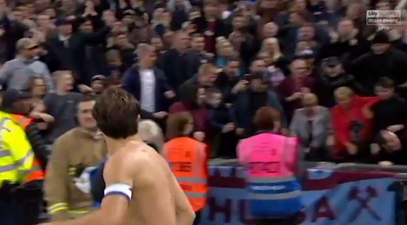  Noble and fans in the West Ham end look on as the man falls to the floor