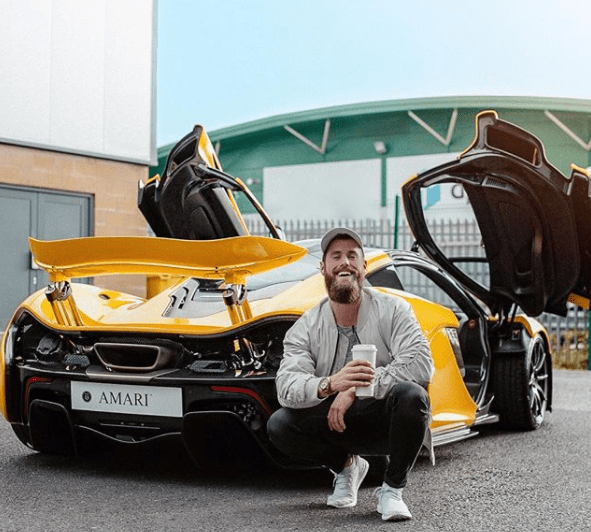  Tom Exton poses in front of a £1.7m bright yellow McLaren P1