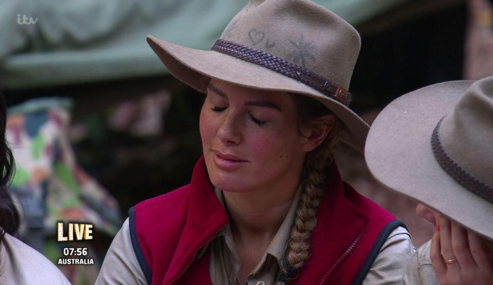  Rebekah has wrote a love heart and a 'U' on her hat with what appears to be charcoal