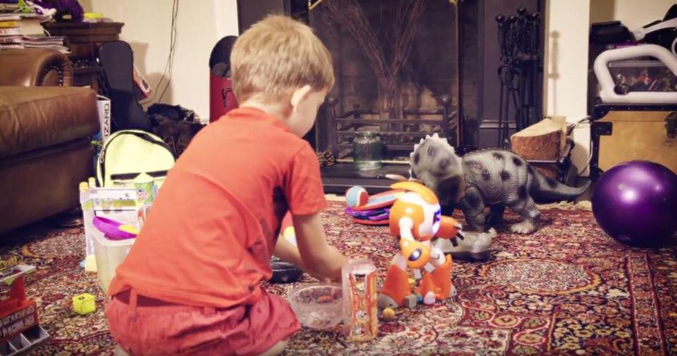  Which? show a child playing with an i-Que robot in his living room