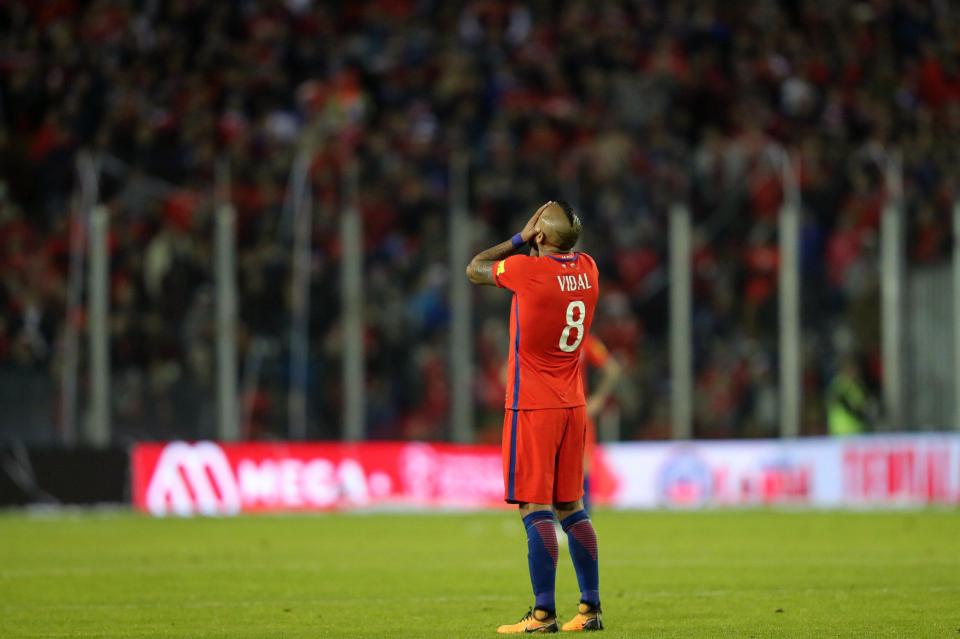 Arturo Vidal takes a moment to accept that Chile will not be at World Cup