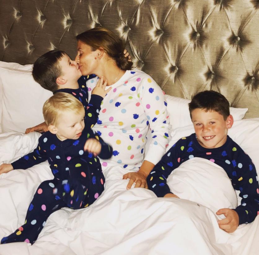 Coleen Rooney shared a cute snap of herself cuddling up to her three sons in bed, yesterday