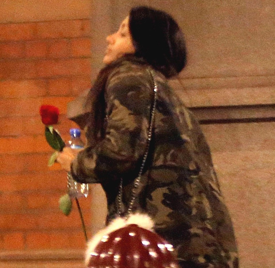 Khans female companion was seen holding a single red rose 