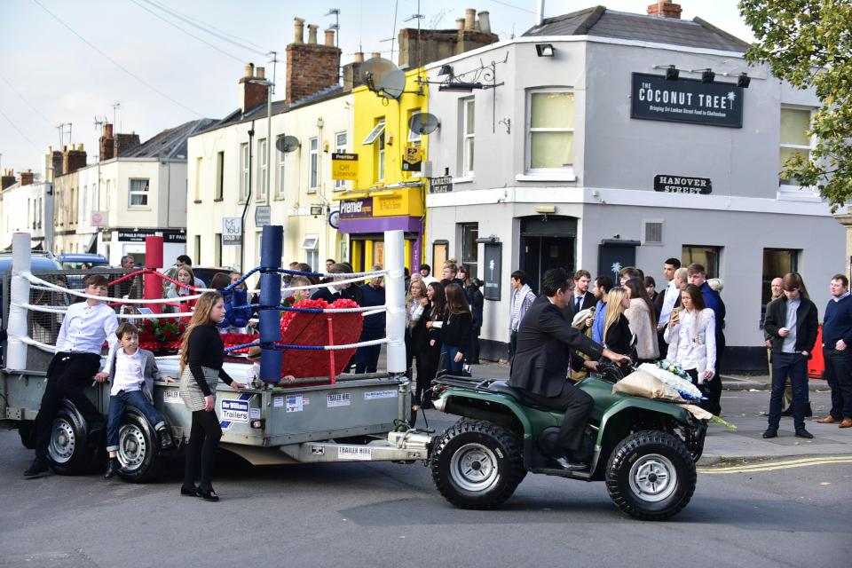 Jesse Johnson's funeral procession drew a huge crowd as his coffin was carried to church on a trailer shaped like a boxing ring