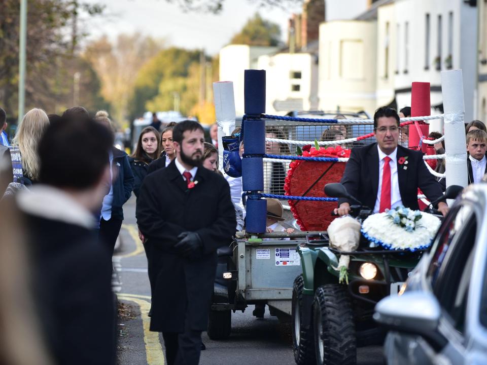 Family members accompanied the trailer carrying his coffin to the church