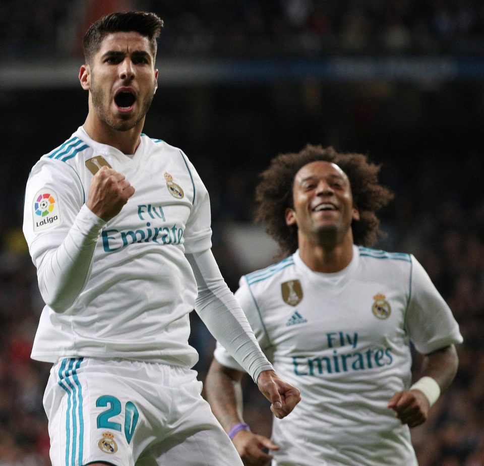 Marco Asensio roars his approving at his stunnign goal as Marcelo rushes to congratulate him