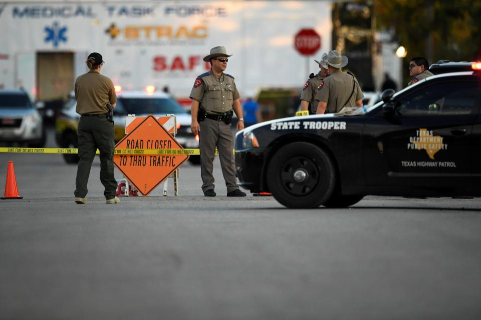  Cops stand guard at the scene of yesterday's horrific shooting