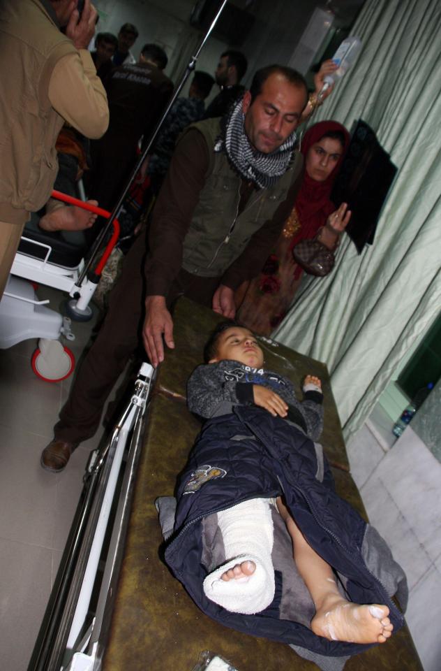  A child injured in the earthquake waits for aid at Sulaimaniyah Hospital