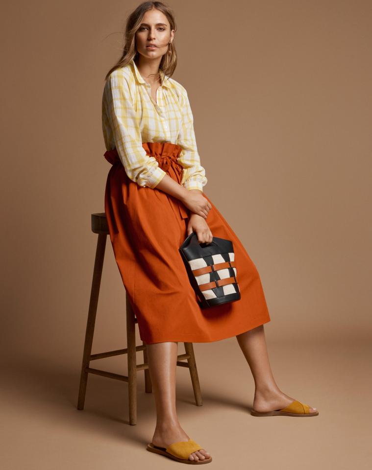  I love the skirt’s colour and the high-waisted detail will cinch in your waist. The shirt subtly adds colour to your wardrobe. Shirt, £25; skirt, £35; earrings,£12.50; bag, £32.50; shoes, £25