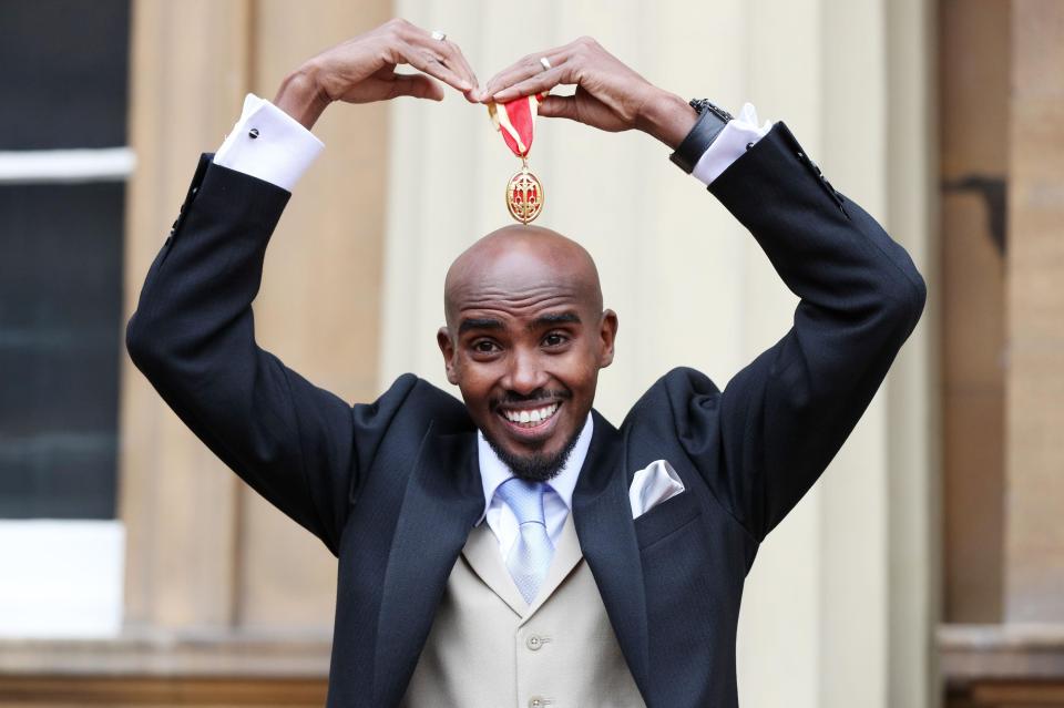  Mo Farah strikes his trademark 'Mobot' pose outside Buckingham Palace