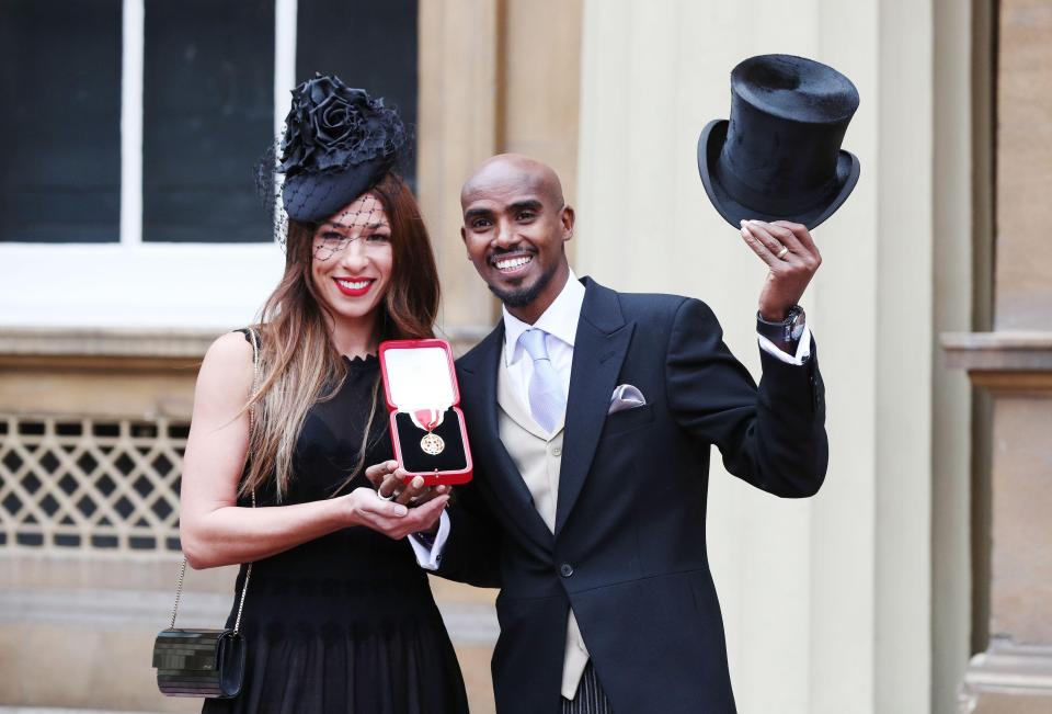  Mo Farah raises his hat outside the Palace with Tania and his medal