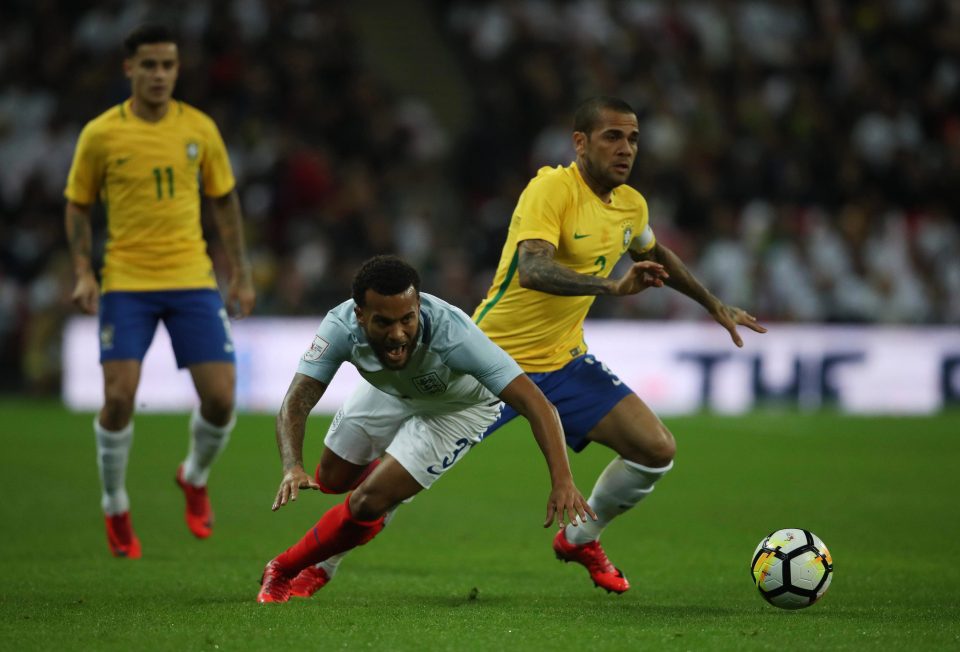  Full-back's Dani Alves and Ryan Bertrand vie for the ball during the first half