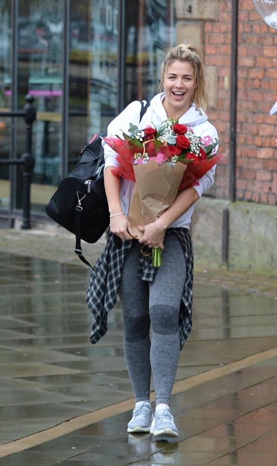  Birthday girl Gemma Atkinson beams as she's pictured clutching flowers