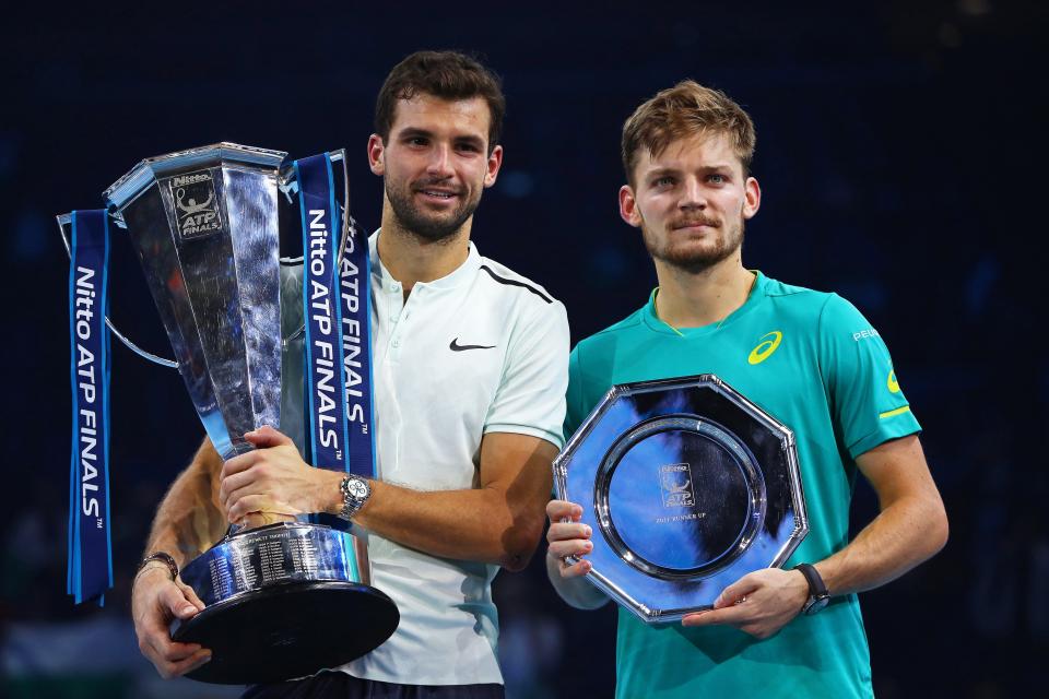  Grigor Dimitrov poses with his winners trophy next to his Belgian opponent