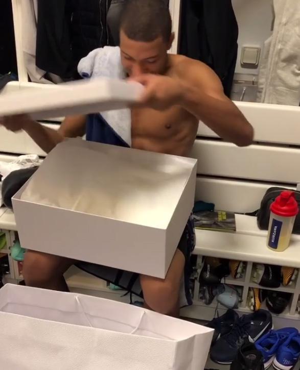  The 18-year-old opened the box in anticipation whilst his team-mates watched on