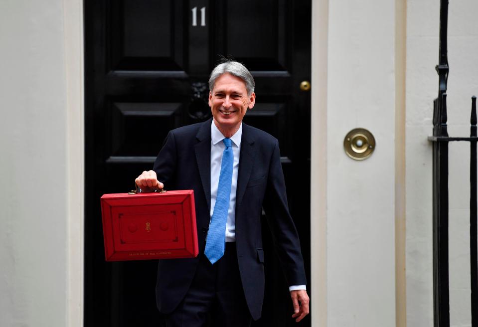  Philip Hammond holding up his red box outside 11 Downing Street