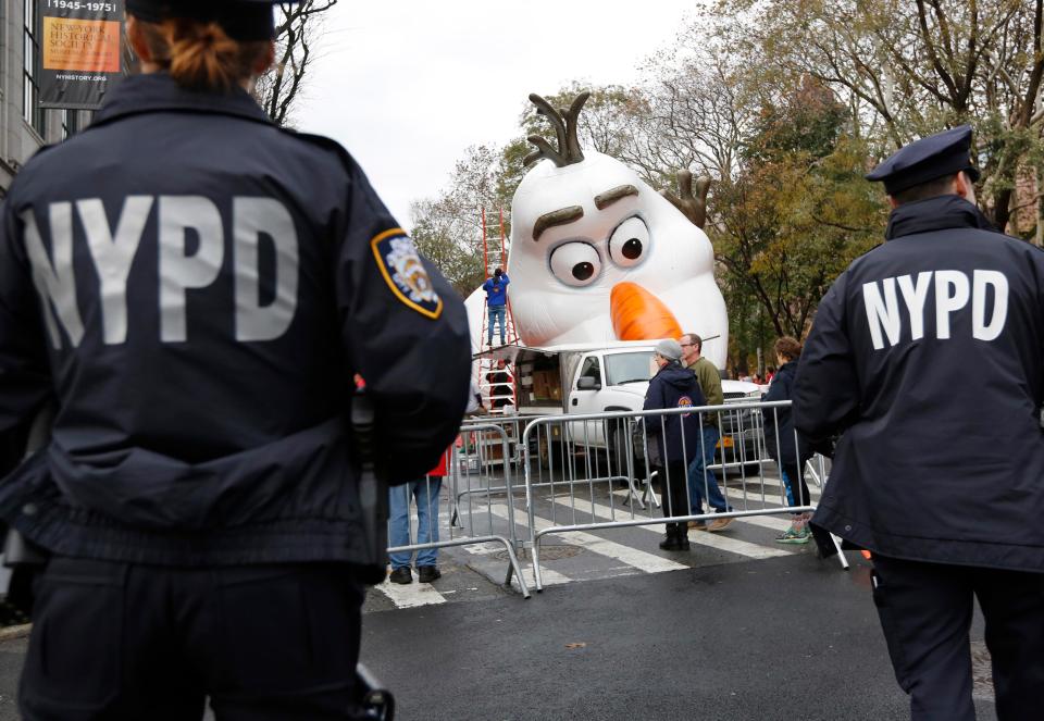  Gun-toting anti-terror cops watch a balloon designed to look like Olaf from Disney's Frozen