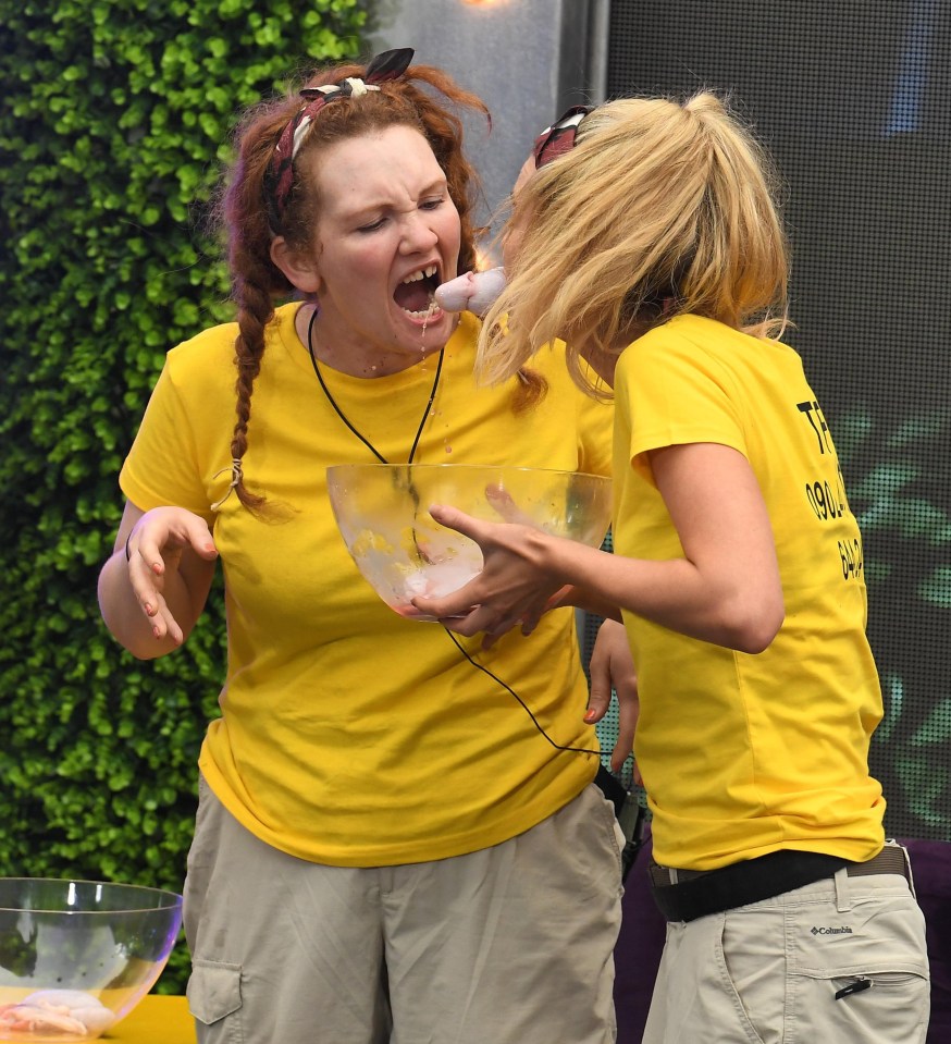 Jennie and Georgia did not look happy to be passing bull testicles using their mouths