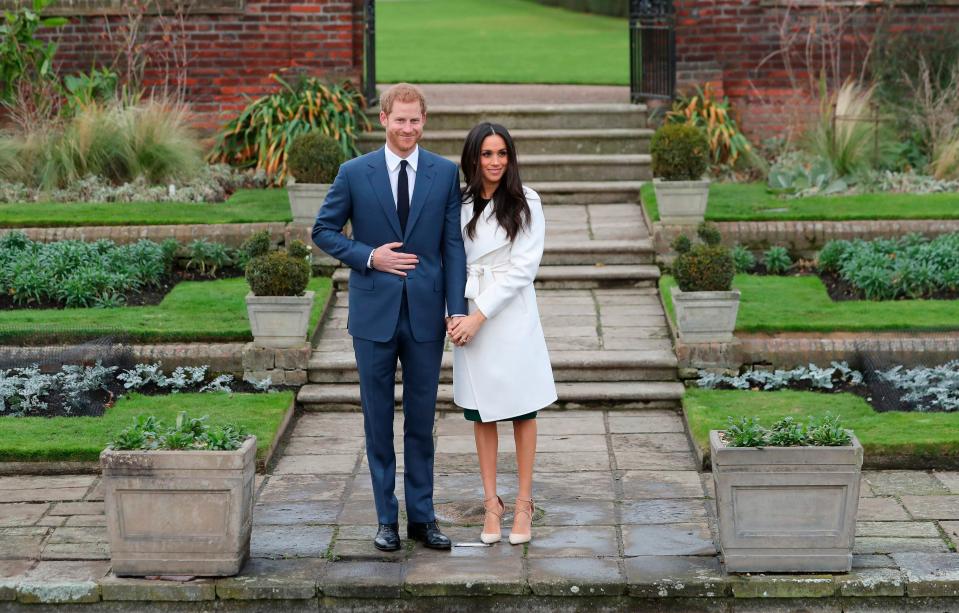  Meghan didn't let go of Harry's hand as they stood in front of photographers today