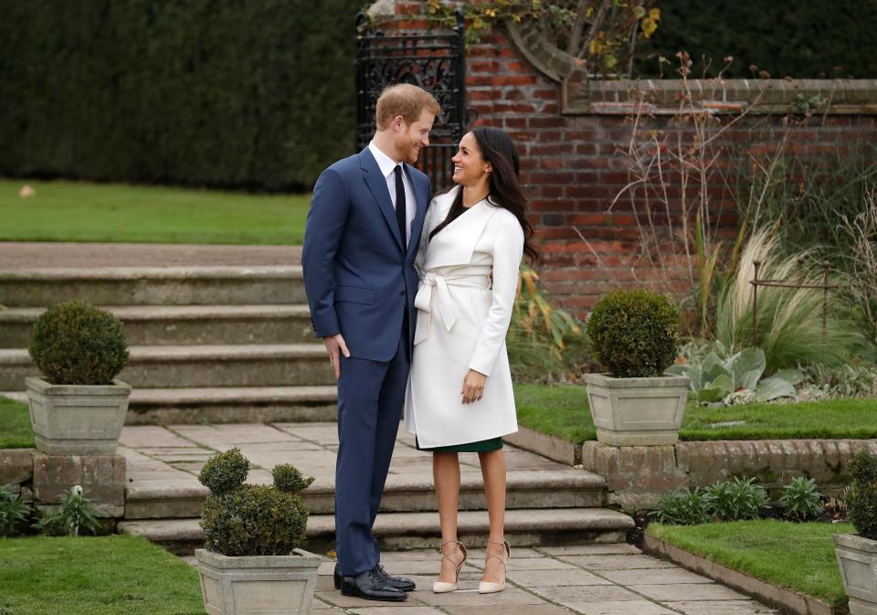  The newly engaged couple stood by the steps of the Sunken Garden as they were snapped by photographers