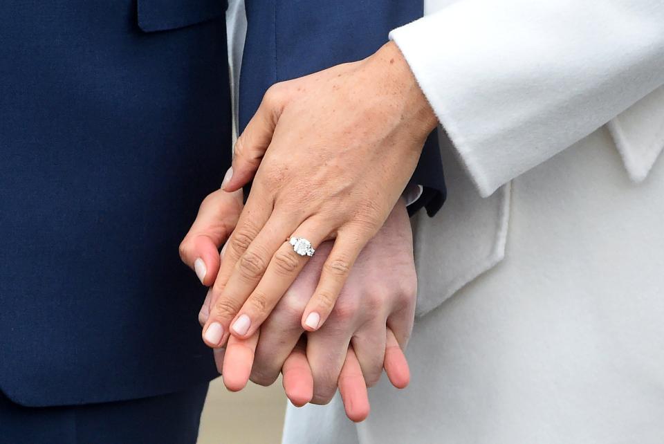  The stunning, yellow gold ring was designed by Prince Harry himself and includes a central stone from Botswana and two diamonds from Diana's collection