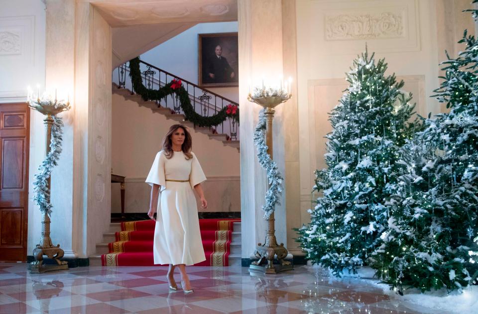  Mrs Trump strode down a hallway from the private residence as she prepared to inspect the decorations