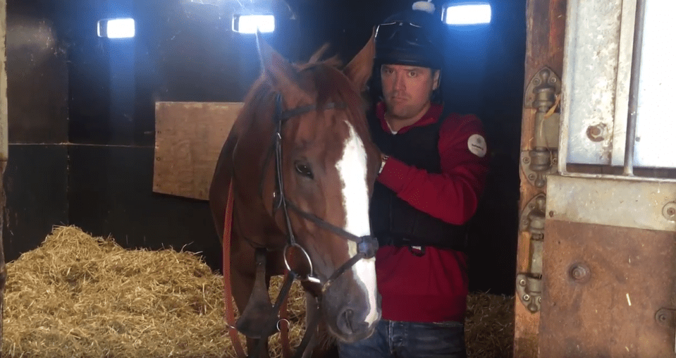 Owen in the stables with a horse ahead of his debut as a jockey