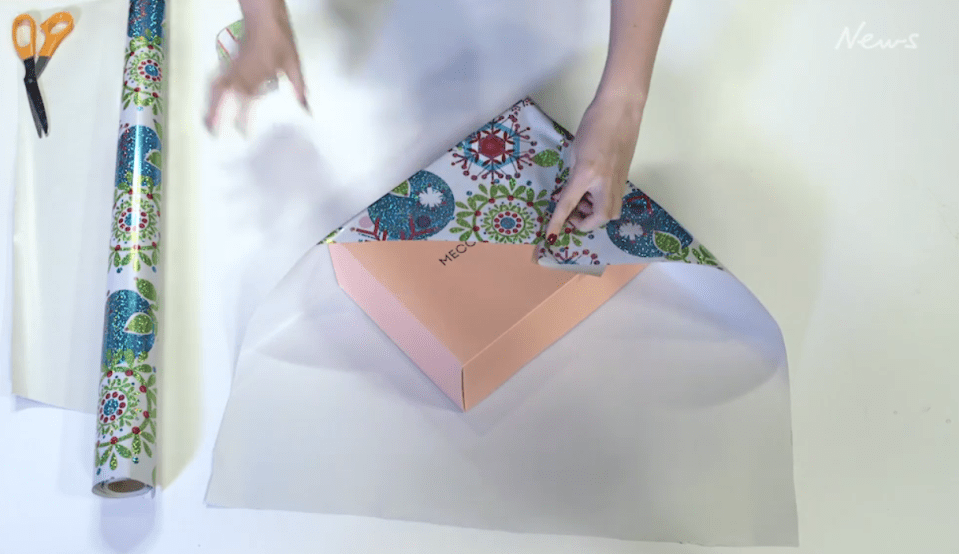  Fold in two end corners from the rectangular sheet and hold in place