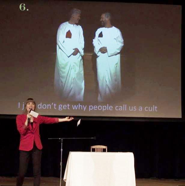  Clyne delivers a speech at a Nxivm event in 2016 - in front of a picture captioned "I just don't get why people call us a cult"