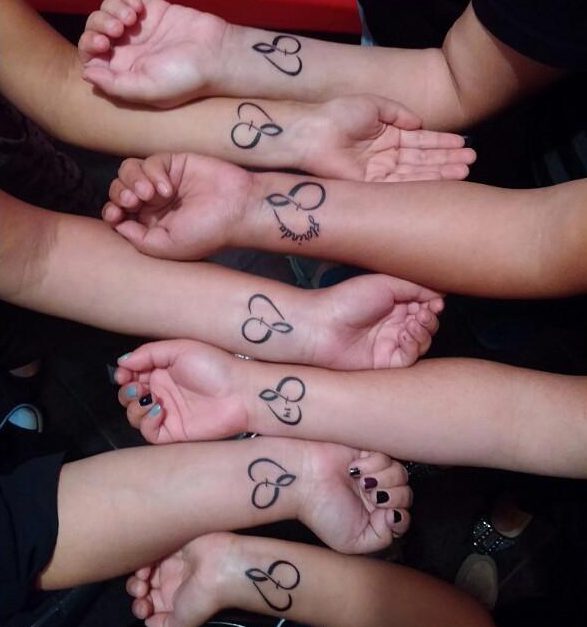  Seven pals showcased their love for one another by getting matching heart tatts on their wrists