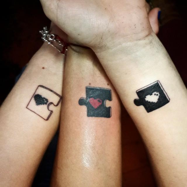  Together these three heart tattoos make up a completed puzzle