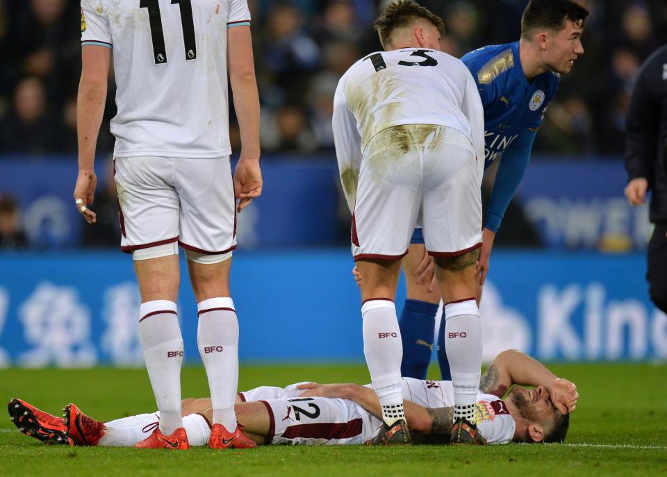  The former Norwich star lays on the ground after the heavy tackle