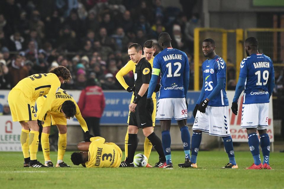  PSG defender Presnel Kimpembe lies on the pitch injured in the first half