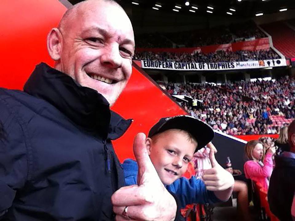  The 14-year-old is pictured with his dad at Manchester United's stadium