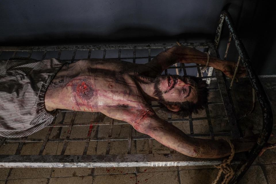  A mutilated wax dummy lies strapped to a bed frame at the prison turned museum