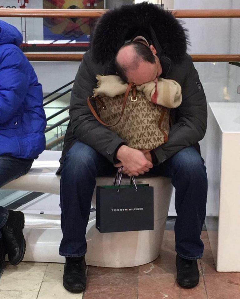  This gentleman is casually using his missus' handbag as a pillow