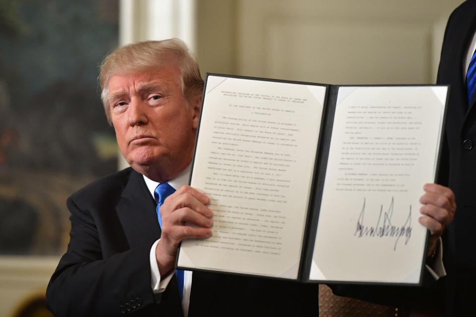  Trump signing his Presidential order on Jerusalem. His move has been criticised by allies and opponents