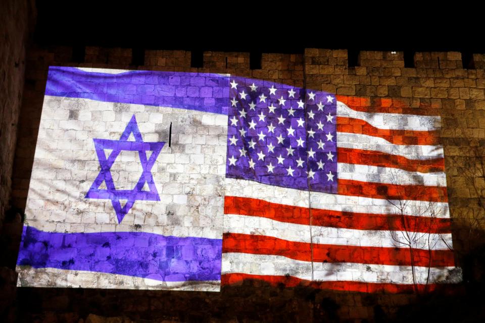  An image of an Israeli and American flag is projected on the wall of Jerusalem's Old City in celebration tonight