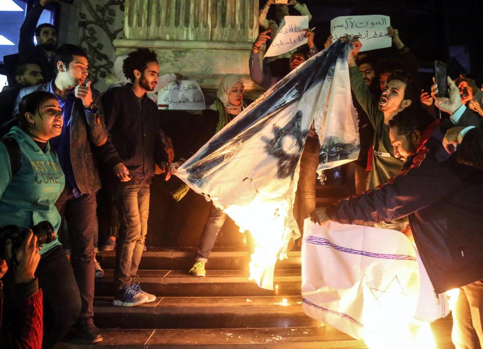  An Israeli flag is burned in a protest in Cairo, Egypt as demonstrators took to the streets across the Middle East