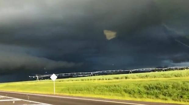  It's actually the reflection of the man recording the storm being picked up on camera.