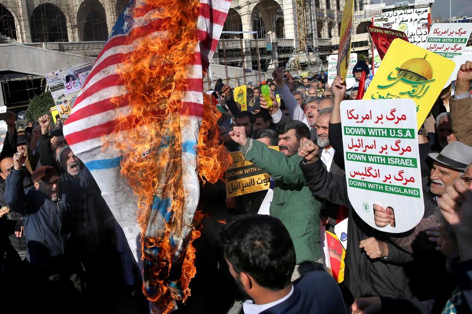  The US flag is burnt on the streets of Tehran, Iran, today