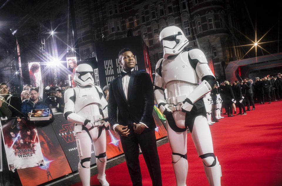  John Boyega - who plays Finn in the latest installment of the Stars Wars franchise - poses alongside two Stormtroopers at the films Premiere earlier this week.