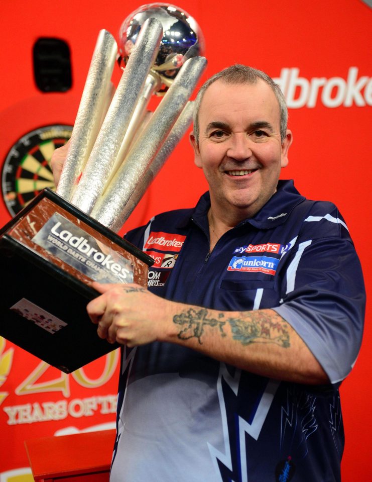 Phil Taylor celebrates after his last world title triumph in 2013