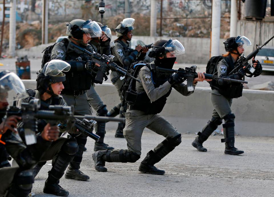 Israeli border guards take aim as Palestinian protesters gather in the West Bank city of Ramallah