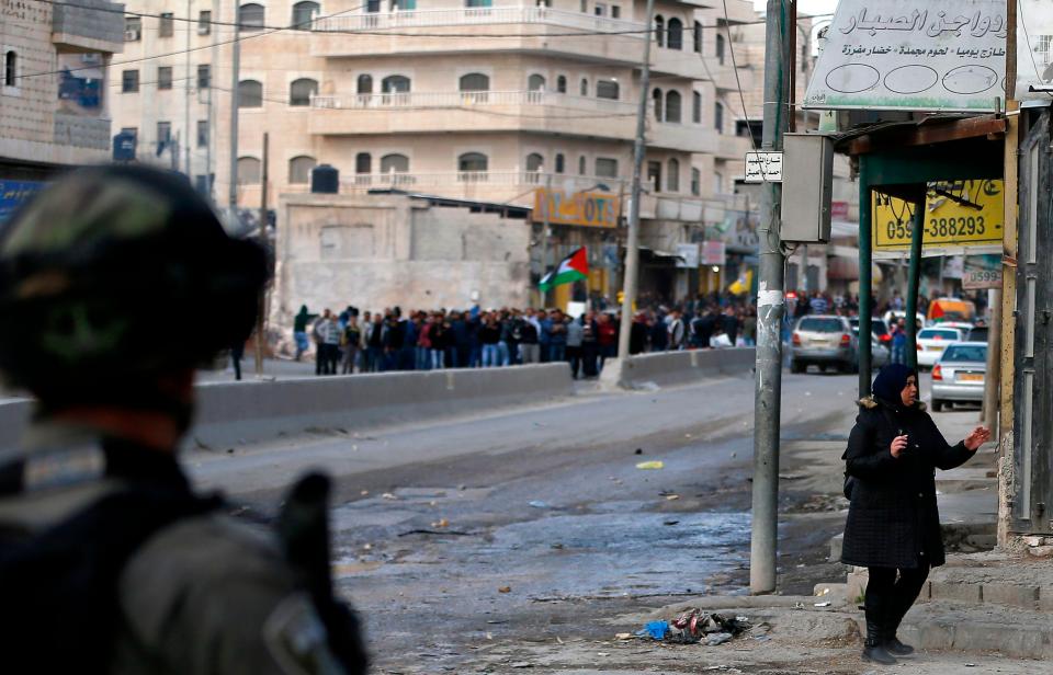  Israeli security forces stand guard as Palestinian protesters gather in the West Bank city of Ramallah