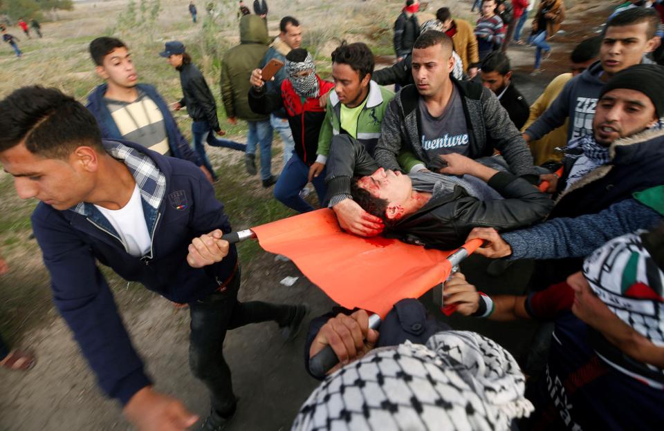 A wounded Palestinian demonstrator is evacuated during clashes with Israeli troops near the border with Israel in the east of Gaza City