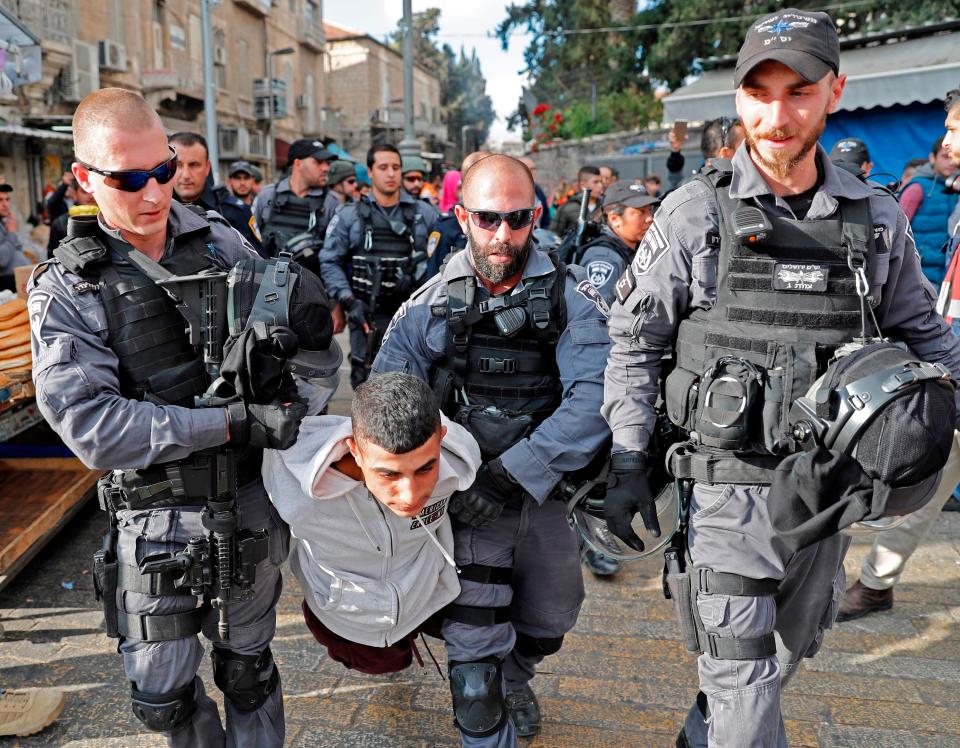 Israeli security forces drag off a Palestinian youth after arresting him in Jerusalem 