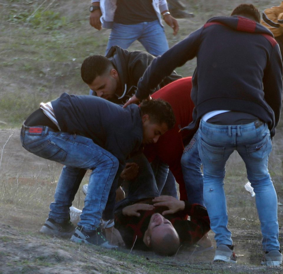 A Palestinian demonstrator is evacuated after inhaling tear gas fired by Israeli troops in Gaza City 