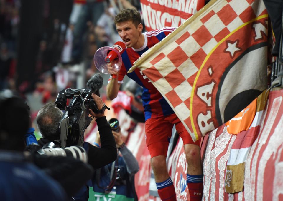  Thomas Muller leads the Bayern Munich faithful with a song